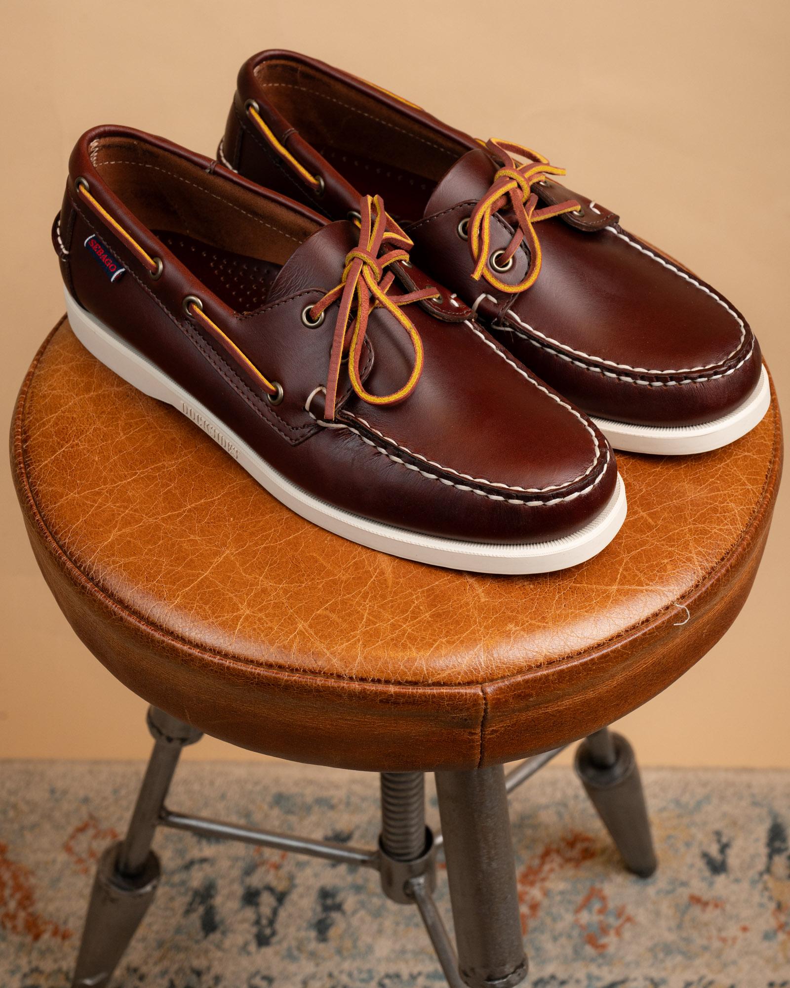 Scarpe da barca Sebago Docksides Portland Paxed marrone scuro con suola in gomma bianca e lacci in cuoio.
